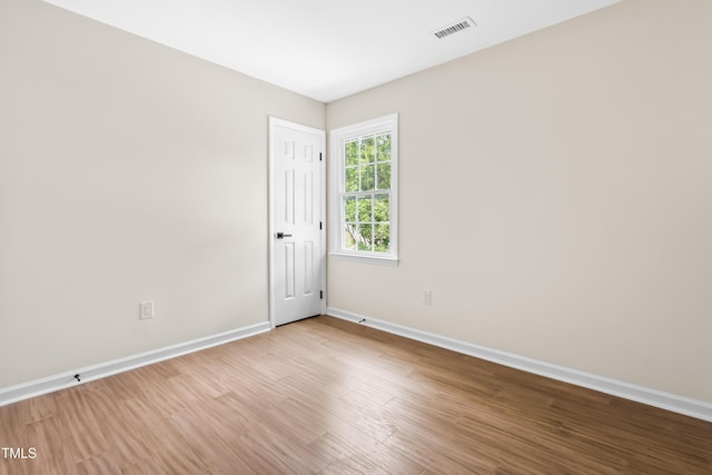 empty room featuring baseboards and wood finished floors