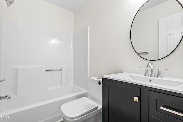 bathroom featuring toilet, vanity, and shower / washtub combination
