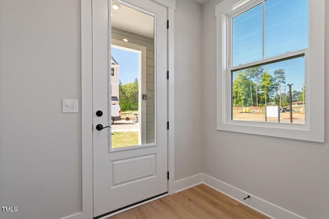 entryway featuring baseboards and light wood finished floors