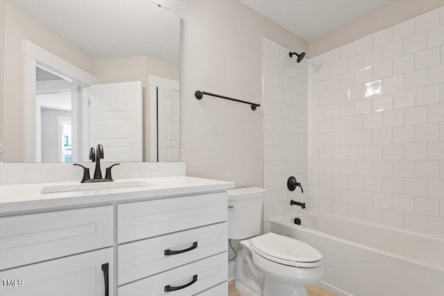 bathroom featuring toilet, shower / tub combination, and vanity