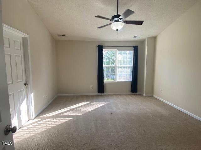 21 Suncrest Ct, Durham, NC 27703 - carpeted empty room with baseboards, ceiling fan, and a textured ceiling