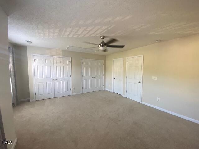 21 Suncrest Ct, Durham, NC 27703 - unfurnished bedroom with two closets, baseboards, carpet, and ceiling fan
