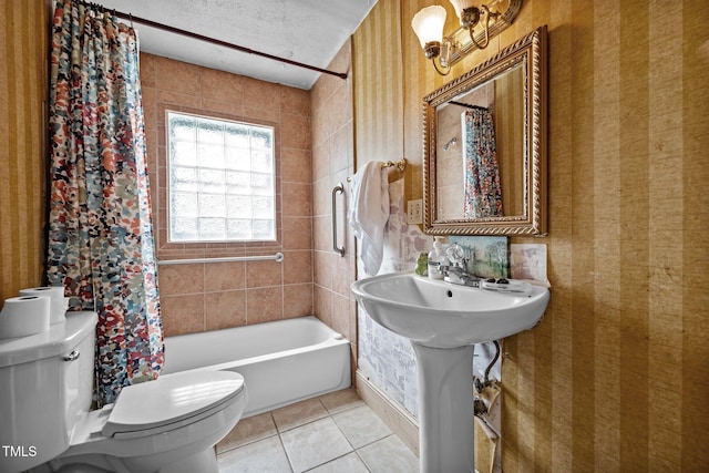 full bathroom with toilet, tile patterned flooring, wallpapered walls, and shower / bath combo with shower curtain