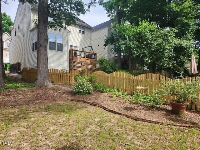 view of yard with fence and a deck