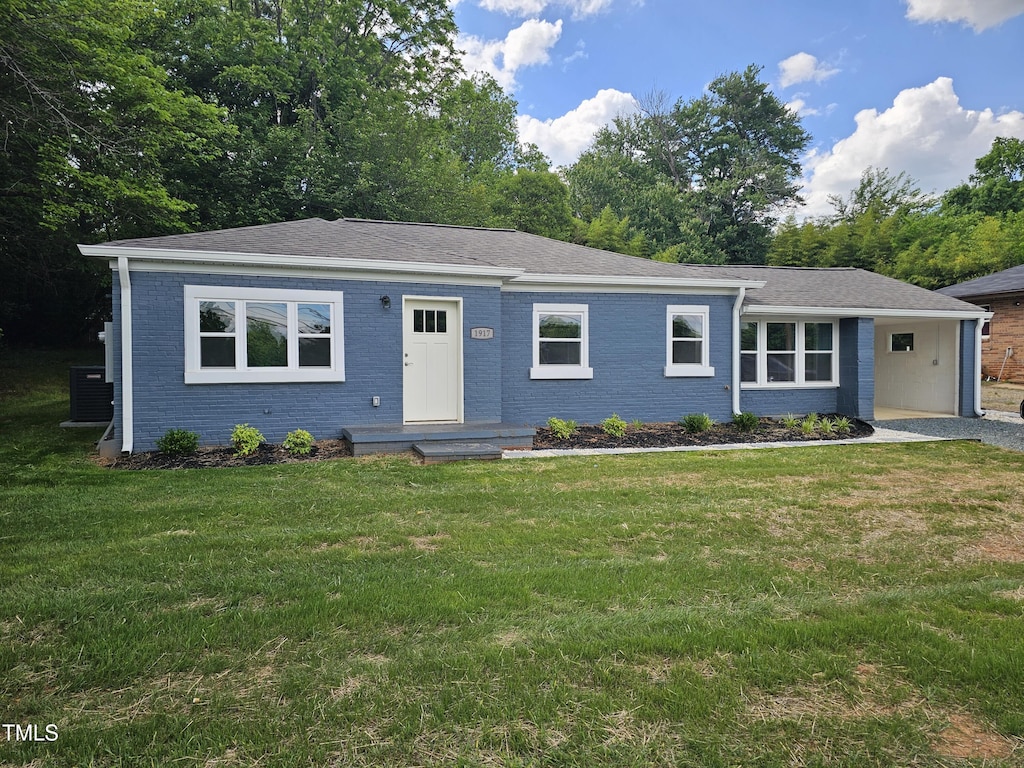 view of front facade featuring brick siding, a front lawn, central air condition unit, and a shingled roof