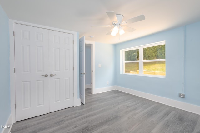 1917 Tucker St, Burlington, NC 27215 - unfurnished bedroom with a closet, wood finished floors, baseboards, and a ceiling fan