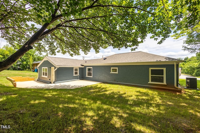 1917 Tucker St, Burlington, NC 27215 - rear view of house featuring central air condition unit, a patio area, a lawn, and brick siding