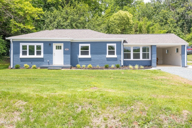 1917 Tucker St, Burlington, NC 27215 - view of front of house with driveway, a front lawn, an attached carport, and brick siding