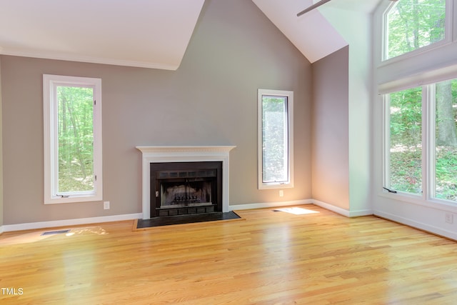 5314 Taproot Ln, Durham, NC 27705 - unfurnished living room featuring wood finished floors, high vaulted ceiling, baseboards, and a fireplace with flush hearth