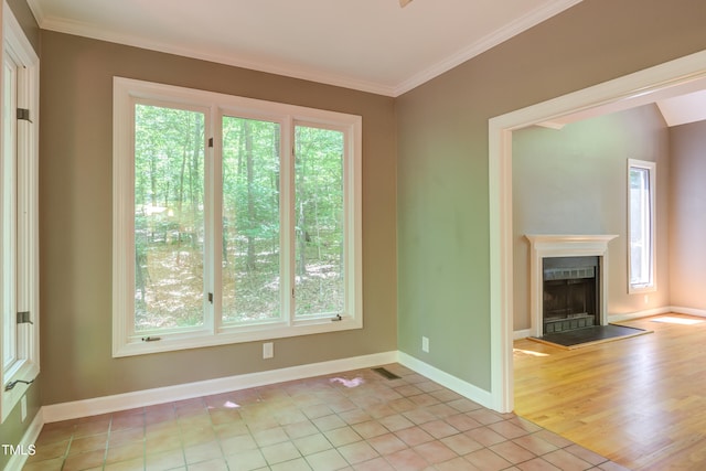 5314 Taproot Ln, Durham, NC 27705 - unfurnished living room with crown molding, a fireplace with raised hearth, baseboards, and light tile patterned flooring