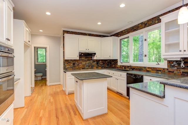 5314 Taproot Ln, Durham, NC 27705 - kitchen featuring under cabinet range hood, ornamental molding, a sink, white cabinets, and decorative backsplash