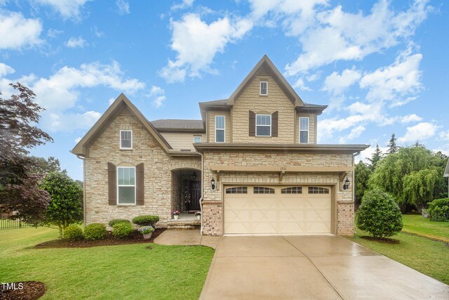 1201 Pleasant Falls Ct, Wake Forest, NC 27587 - view of front of home featuring driveway, an attached garage, a front yard, and stone siding