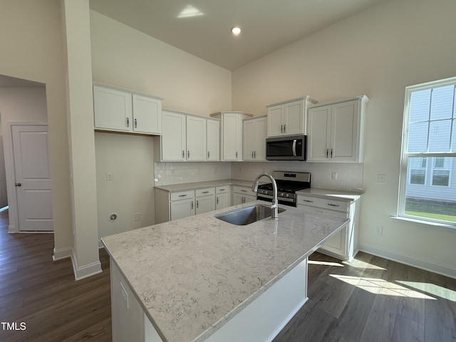 367 Whitley Ridge Dr, Clayton, NC 27527 - kitchen with appliances with stainless steel finishes, a sink, white cabinetry, light stone counters, and baseboards