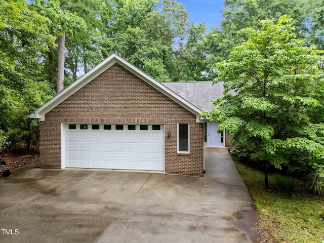 224 Crawford Rd, Hillsborough, NC 27278 - view of front facade featuring brick siding, a garage, and driveway