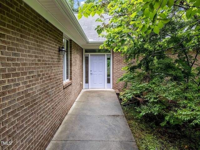224 Crawford Rd, Hillsborough, NC 27278 - view of exterior entry with brick siding and a shingled roof