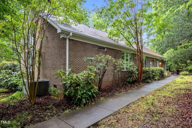 224 Crawford Rd, Hillsborough, NC 27278 - view of side of home with brick siding and central AC