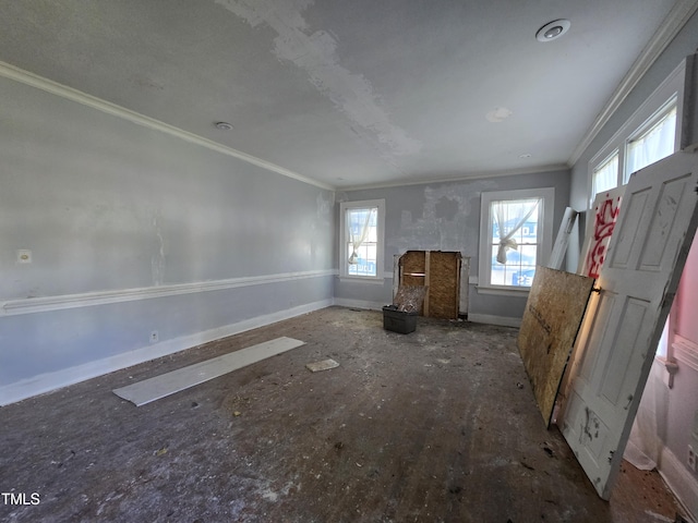 500 Vance St NE, Wilson, NC 27893 - unfurnished living room featuring ornamental molding, healthy amount of natural light, and baseboards