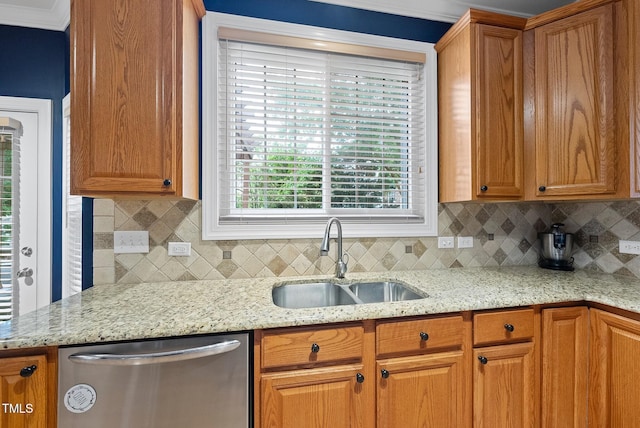 kitchen with dishwasher, a sink, backsplash, and brown cabinets