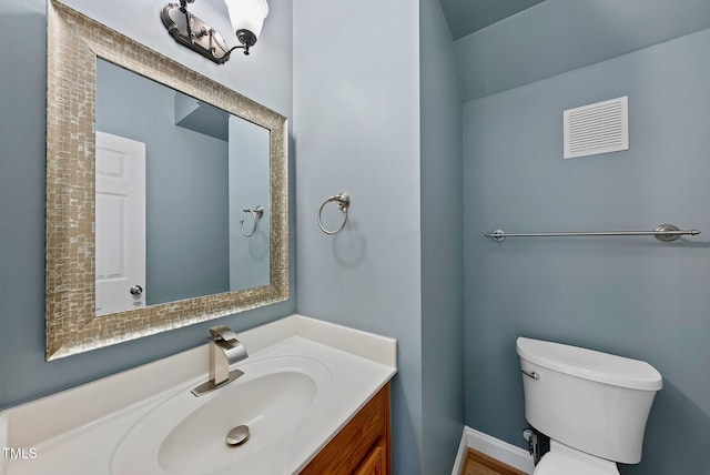 bathroom featuring toilet and vanity