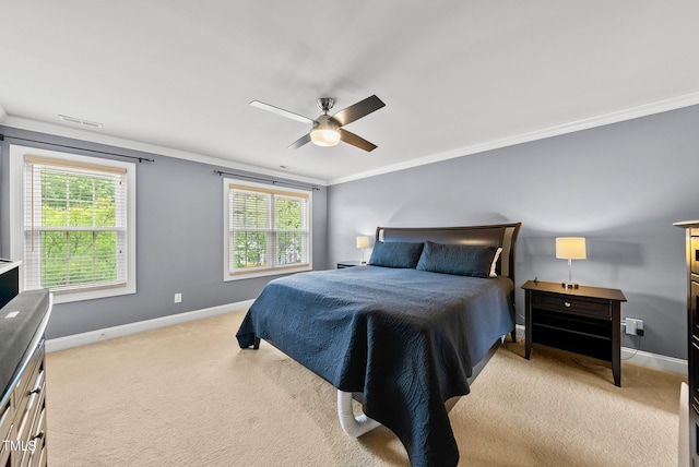 bedroom featuring ornamental molding, light carpet, baseboards, multiple windows, and ceiling fan