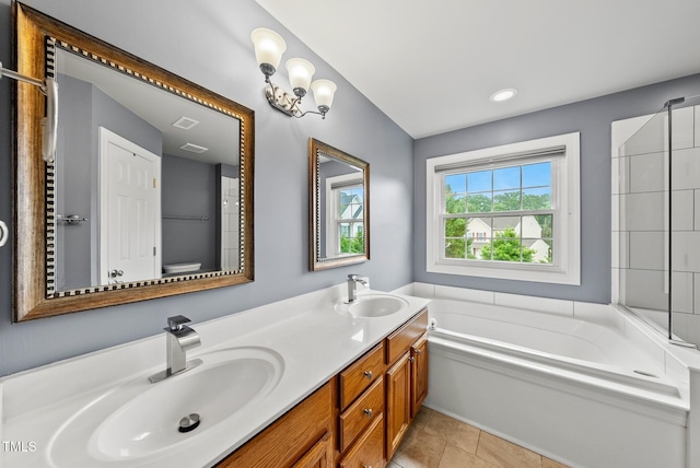 full bath featuring a bath, double vanity, and tile patterned floors