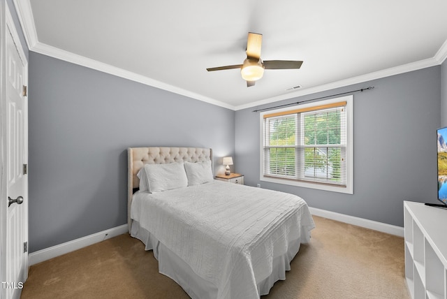 carpeted bedroom featuring crown molding, baseboards, and a ceiling fan