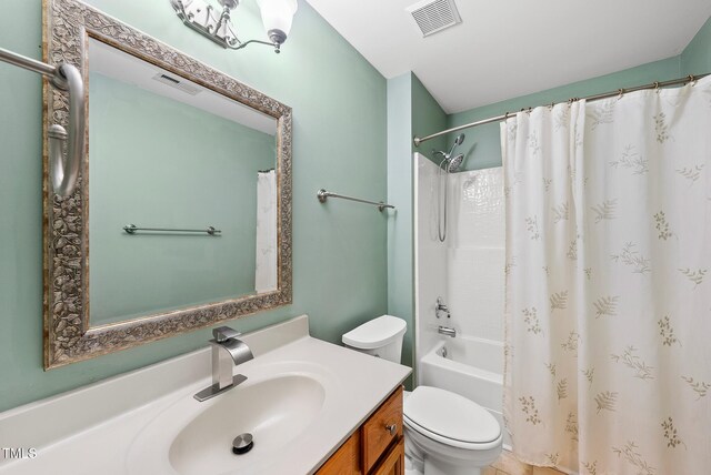 bathroom featuring toilet, vanity, and shower / bathtub combination with curtain