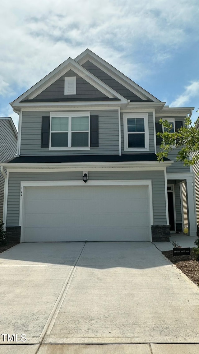 3112 Star Gazing Ln, Durham, NC 27703 - view of front of property featuring an attached garage, concrete driveway, and stone siding