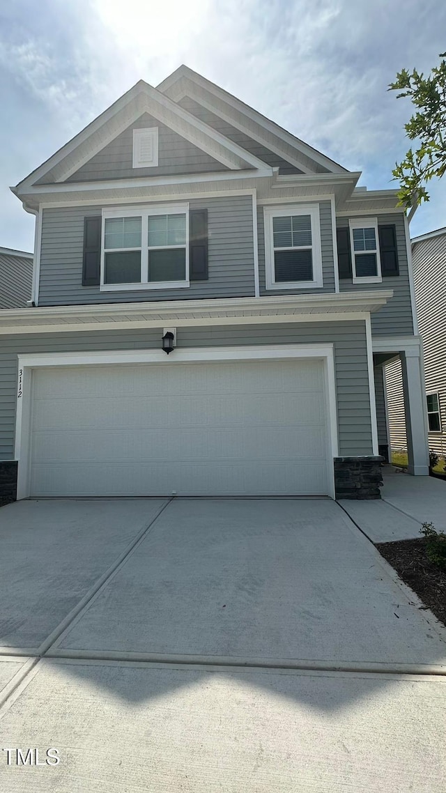 3112 Star Gazing Ln, Durham, NC 27703 - view of front of property featuring an attached garage, driveway, and stone siding