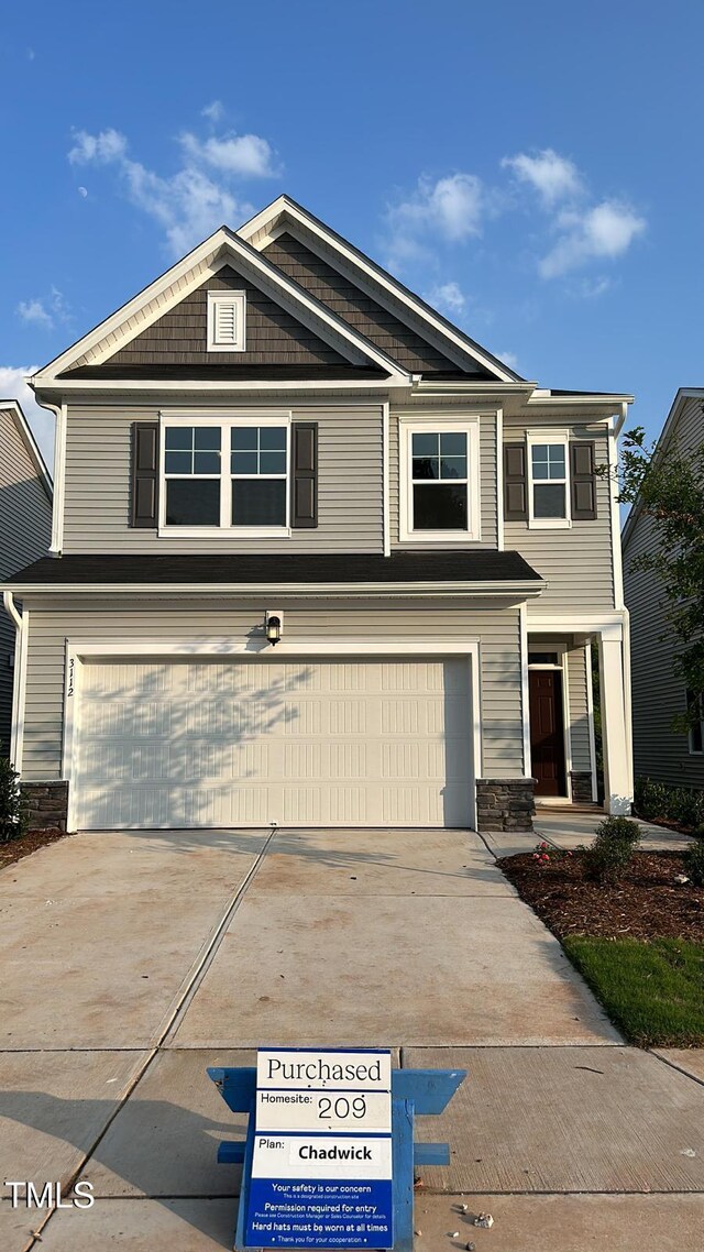 3112 Star Gazing Ln, Durham, NC 27703 - view of front of home featuring a garage, driveway, and stone siding