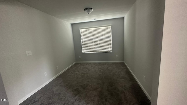 3112 Star Gazing Ln, Durham, NC 27703 - spare room featuring dark colored carpet and baseboards