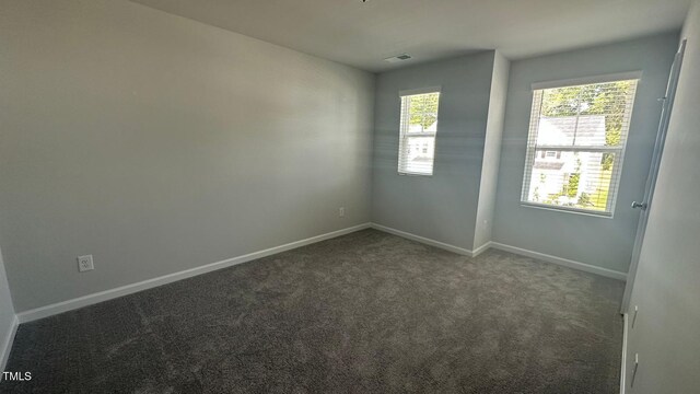 3112 Star Gazing Ln, Durham, NC 27703 - empty room featuring dark colored carpet and baseboards