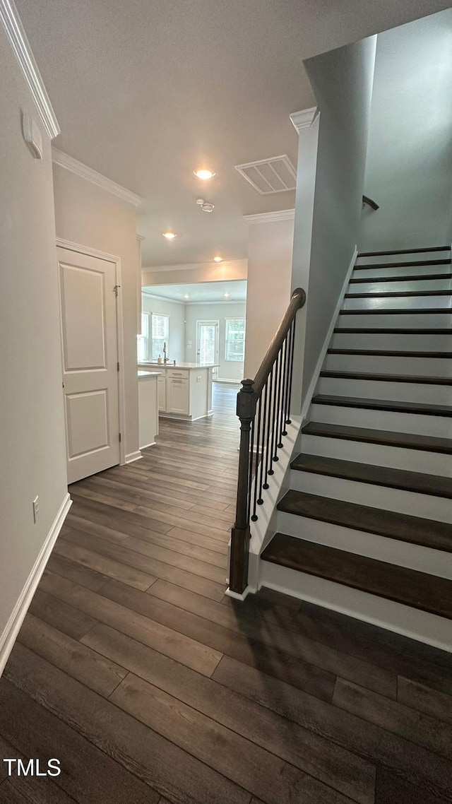 3112 Star Gazing Ln, Durham, NC 27703 - stairway featuring crown molding, wood finished floors, baseboards, and recessed lighting