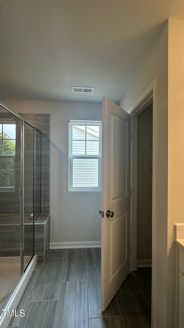 3112 Star Gazing Ln, Durham, NC 27703 - bathroom featuring a shower stall, plenty of natural light, and baseboards