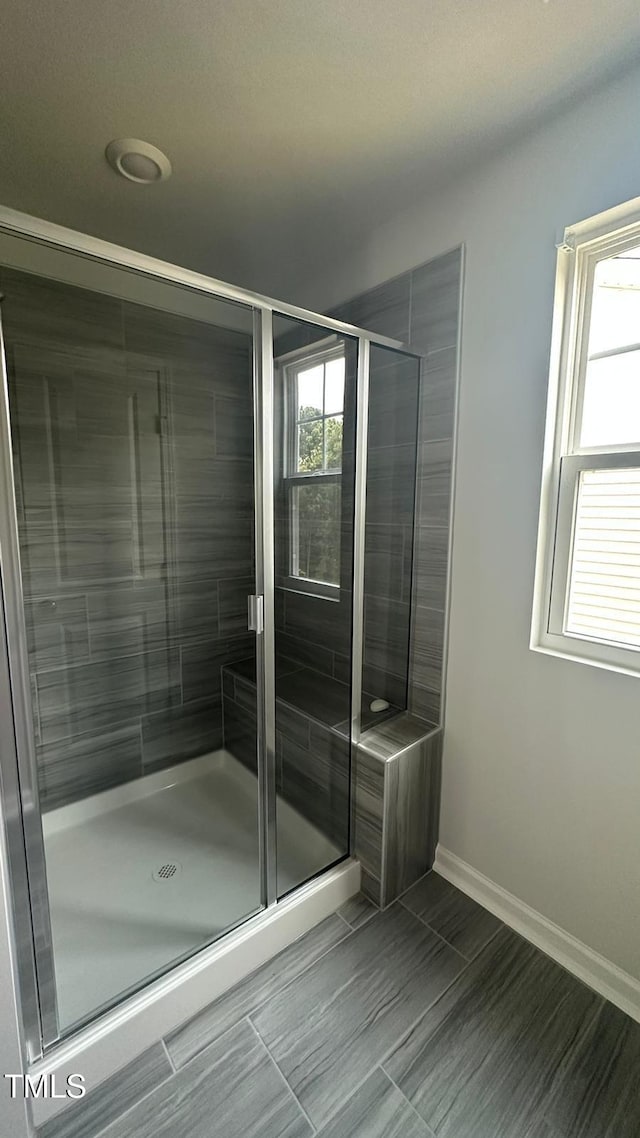 3112 Star Gazing Ln, Durham, NC 27703 - bathroom featuring a stall shower and baseboards