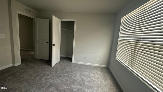 3112 Star Gazing Ln, Durham, NC 27703 - unfurnished bedroom featuring dark carpet, a closet, and baseboards