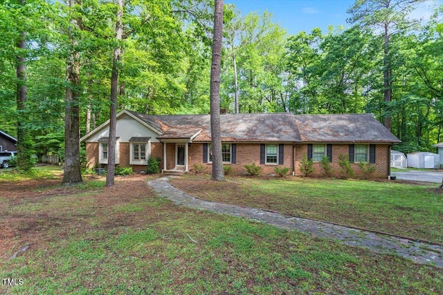 single story home with a front yard and brick siding
