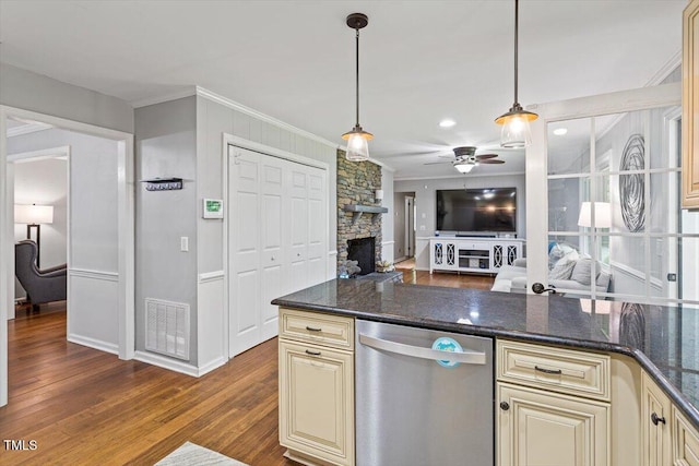 kitchen featuring cream cabinets, stainless steel dishwasher, ornamental molding, a ceiling fan, and dark wood-style floors