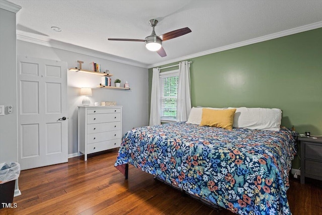 bedroom featuring wood finished floors, crown molding, and a ceiling fan