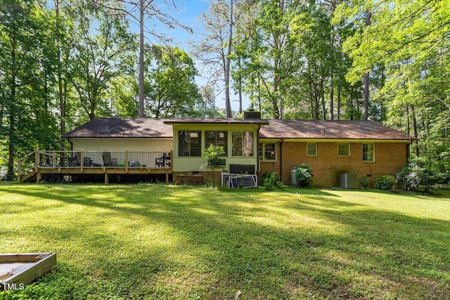 rear view of house featuring central AC, a yard, a wooden deck, and crawl space