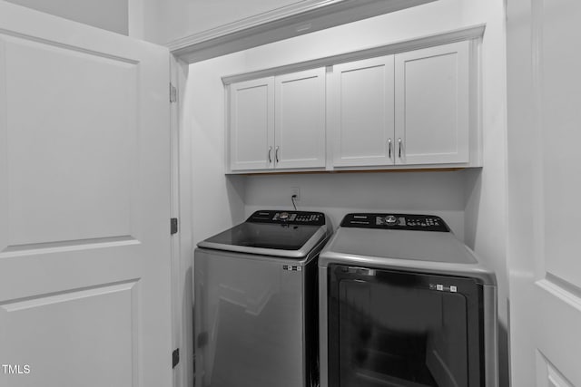 laundry room with cabinet space and washing machine and dryer