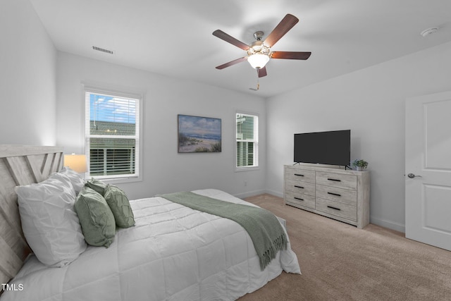 carpeted bedroom with baseboards and a ceiling fan