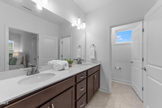 bathroom featuring ensuite bath, double vanity, plenty of natural light, and tile patterned floors