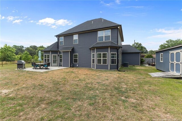 2677 Cypress Lakes Rd, Hope Mills, NC 28348 - back of house with a patio area, central air condition unit, a yard, and a shingled roof
