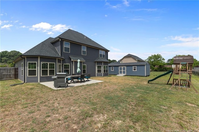 2677 Cypress Lakes Rd, Hope Mills, NC 28348 - back of property with a patio area, a playground, and a shingled roof