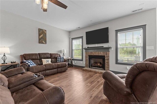 2677 Cypress Lakes Rd, Hope Mills, NC 28348 - living area with a ceiling fan, a brick fireplace, wood finished floors, and baseboards