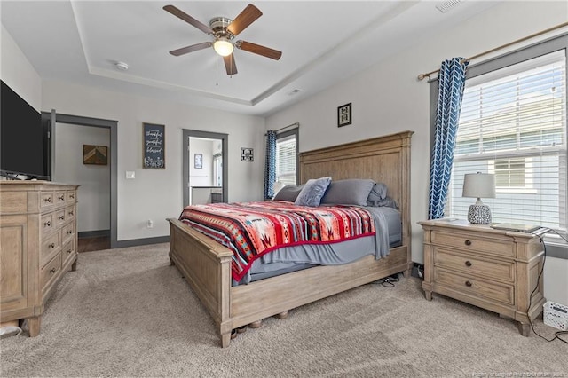 2677 Cypress Lakes Rd, Hope Mills, NC 28348 - bedroom with light carpet, a tray ceiling, and ceiling fan