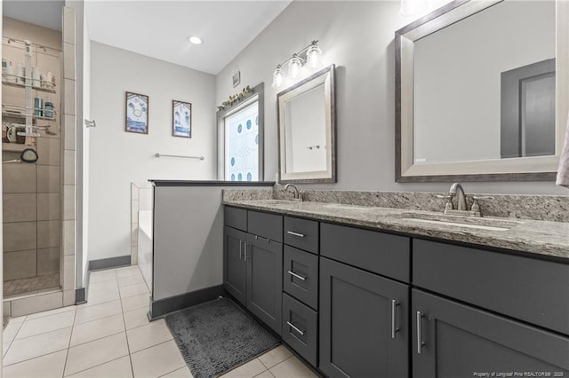 2677 Cypress Lakes Rd, Hope Mills, NC 28348 - bathroom featuring tile patterned flooring, a tile shower, double vanity, a bath, and baseboards
