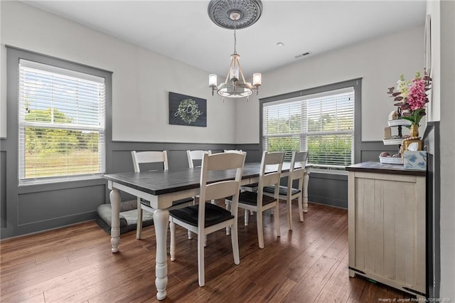 2677 Cypress Lakes Rd, Hope Mills, NC 28348 - dining space featuring a chandelier, dark wood-type flooring, and wainscoting