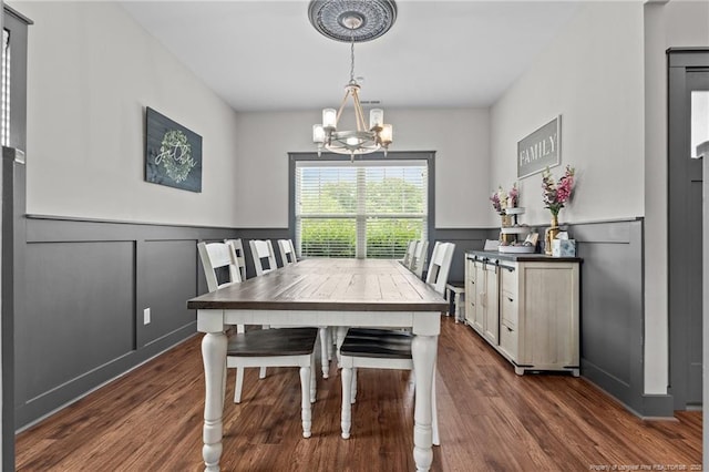 2677 Cypress Lakes Rd, Hope Mills, NC 28348 - dining room with a chandelier, dark wood-type flooring, a decorative wall, and wainscoting